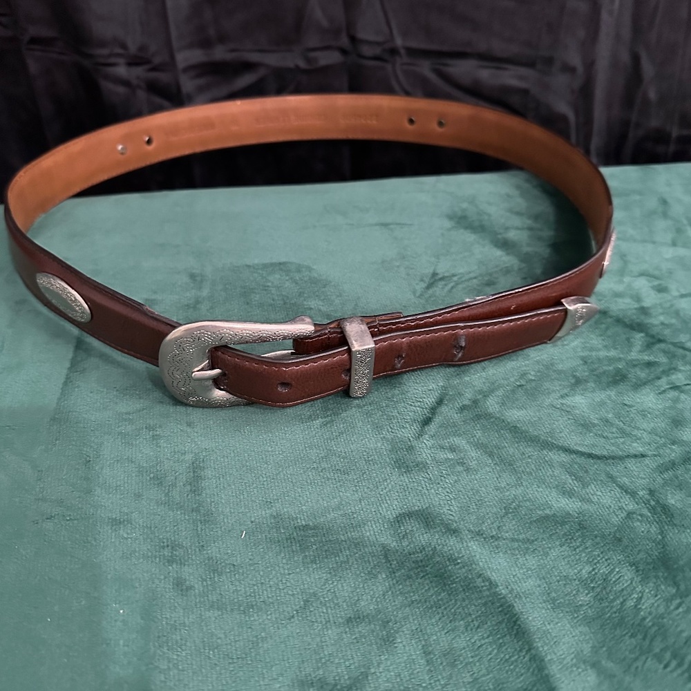 Brown leather tapered belt with silver buckle. (33)